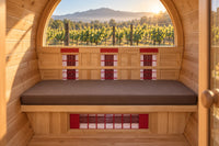 Brown cushion inside a barrel sauna overlooking a vineyard