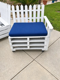 Blue cushion on a white outdoor chair